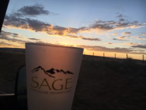 glass that says sage against sunset