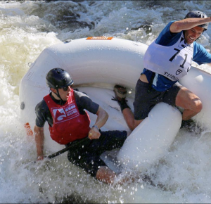two men nearly fall in water whitewater rafting